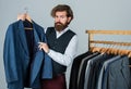 Man in custom tailored suit presenting tailored tuxedo. Man clothing in boutique. tailor in his workshop. Handsome Royalty Free Stock Photo