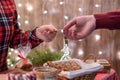 Man customer buying christmas sweets, gingerbread at the bakery giving credit card to the woman seller. Royalty Free Stock Photo