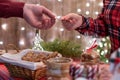 Man customer buying christmas sweets, gingerbread at the bakery giving credit card to the woman seller. Royalty Free Stock Photo