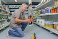 Man customer buying glue in housewares hypermarket