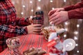 Man  customer buying hot chocolate, coffee in a paper cup, sweets at the christmas bakery. Take away. Royalty Free Stock Photo