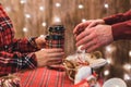 Man  customer buying hot chocolate, coffee in a paper cup, sweets at the christmas bakery. Take away. Royalty Free Stock Photo