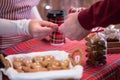 Man  customer buying hot chocolate in a paper cup, sweets at the christmas bakery giving credit card to the woman seller. Royalty Free Stock Photo