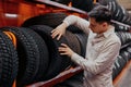 male customer choosing new tires in the supermarket . Royalty Free Stock Photo