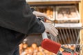 Man customer in protective rubber gloves chooses loaf of bread, in grocery store, supermarket. Protection from bacteria and virus Royalty Free Stock Photo