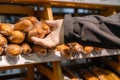 Man customer in protective rubber gloves chooses loaf of bread, in grocery store, supermarket. Protection from bacteria and virus Royalty Free Stock Photo