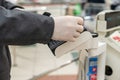 Man customer in protective rubber gloves paying by plastic credit card for purchases. checkout counter in the supermarket. payment Royalty Free Stock Photo