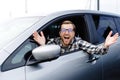 Man customer sitting in car salon and smiling, choosing auto and wanting to buy new automobile in showroom dealership store. Car Royalty Free Stock Photo