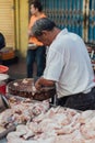 Man cut and sell fresh chicken at morning market in George Town. Penang