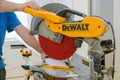 Man cut the wooden molding with circular saw dewalt