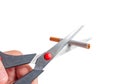 Man cuts a cigarette with scissors