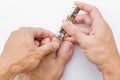 Man cuts his foot nails with tweezers on a white background. Nail care illustration For their good hygiene Royalty Free Stock Photo