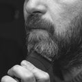 A man cuts his gray beard trimmer close-up Royalty Free Stock Photo