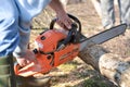 Man cuts tree with chainsaw, concept of deforestation Royalty Free Stock Photo