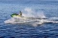 A man cuts the waves on a jet ski on the waters of the Dnieper River in Kherson Ukraine. An adult man glides, creating splashes Royalty Free Stock Photo