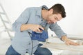 Man cuts wood boards indoors