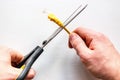 Man cuts yellow network internet cable on white background Royalty Free Stock Photo