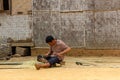 Man cutting a bamboo in a village