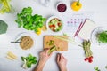 Man cutting celery and cooking vegan fresh salad with vegetables for dinner. Veganuary calendar and daily diet planning. Male