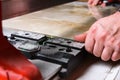 Man cutting ceramic tile with manual tile cutter. Royalty Free Stock Photo