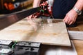 Man cutting ceramic tile with manual tile cutter. Royalty Free Stock Photo