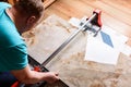 Man cutting ceramic tile with manual tile cutter. Royalty Free Stock Photo