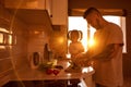 Man cutting cucumber for salad near little daughte Royalty Free Stock Photo