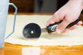 Man cutting dough with roller knife Royalty Free Stock Photo