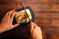 Man cutting a freshly baked whole wheat bread. Royalty Free Stock Photo