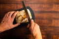 Man cutting a freshly baked whole wheat bread. Royalty Free Stock Photo