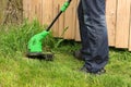 Man cutting the grass with electric trimmer Royalty Free Stock Photo