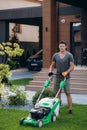 man cutting grass in his garden yard with lawn mower Royalty Free Stock Photo