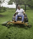 Man cutting grass on lawnmower Royalty Free Stock Photo