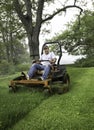 Man cutting grass on lawnmower Royalty Free Stock Photo