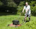 Man cutting grass at suburban house Royalty Free Stock Photo