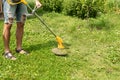 Man cutting the grass in the backyard with a lawn mower, trimmer, detail. Copy space Royalty Free Stock Photo