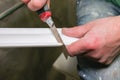 Man is cutting gypsum baseboard with utility knife. Maintenance repair works renovation in the flat . Restoration indoors. Drywall Royalty Free Stock Photo