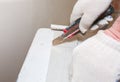 Man is cutting gypsum board with utility knife. Maintenance repair works renovation in the flat . Restoration indoors. Drywall Royalty Free Stock Photo