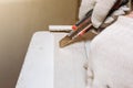 Man is cutting gypsum board with utility knife. Maintenance repair works renovation in the flat . Restoration indoors. Drywall Royalty Free Stock Photo