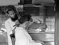 Man cutting hairs in a barber shop in India