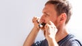 Man cutting his own beard and mustache with scissors and comb. Caucasian red bearded male trimming hair on face at home Royalty Free Stock Photo