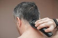 Man cutting his own hair with a clipper Royalty Free Stock Photo