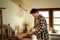 A man cutting ingredients on a board in a warm kitchen Royalty Free Stock Photo