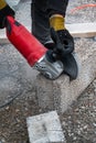 Man cutting light weigt cinder block with angel grinder Royalty Free Stock Photo