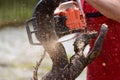 Man cutting lumber with chainsaw