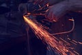 Man cutting metal with angle grinder. Sparks while grinding iron