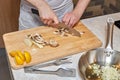 Man cutting an mushrooms with knife on wooden board Royalty Free Stock Photo