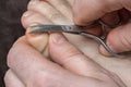 Man cutting nails on his foot - pedicure Royalty Free Stock Photo