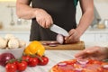 Man cutting onion near woman in kitchen, closeup. Cooking together Royalty Free Stock Photo