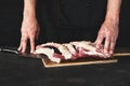 Chef cutting rack of lamb on wooden board Royalty Free Stock Photo